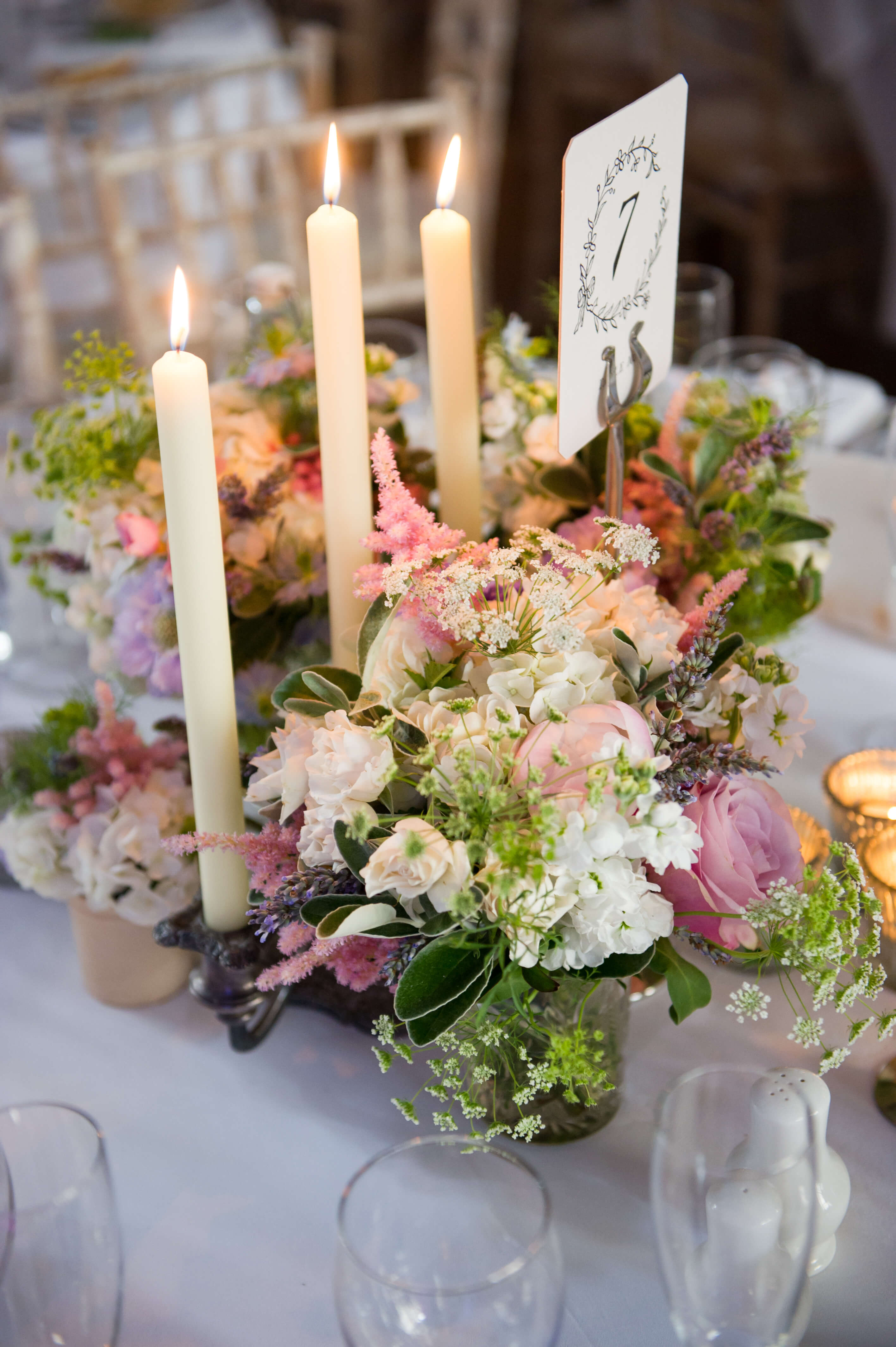 A lit candelabra with floral decoration 